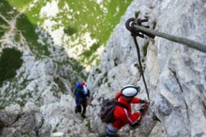 Birdseye View of adventurers taking part in Via Ferrata on mountain side