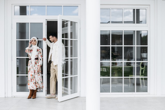 a married couple next to a french door